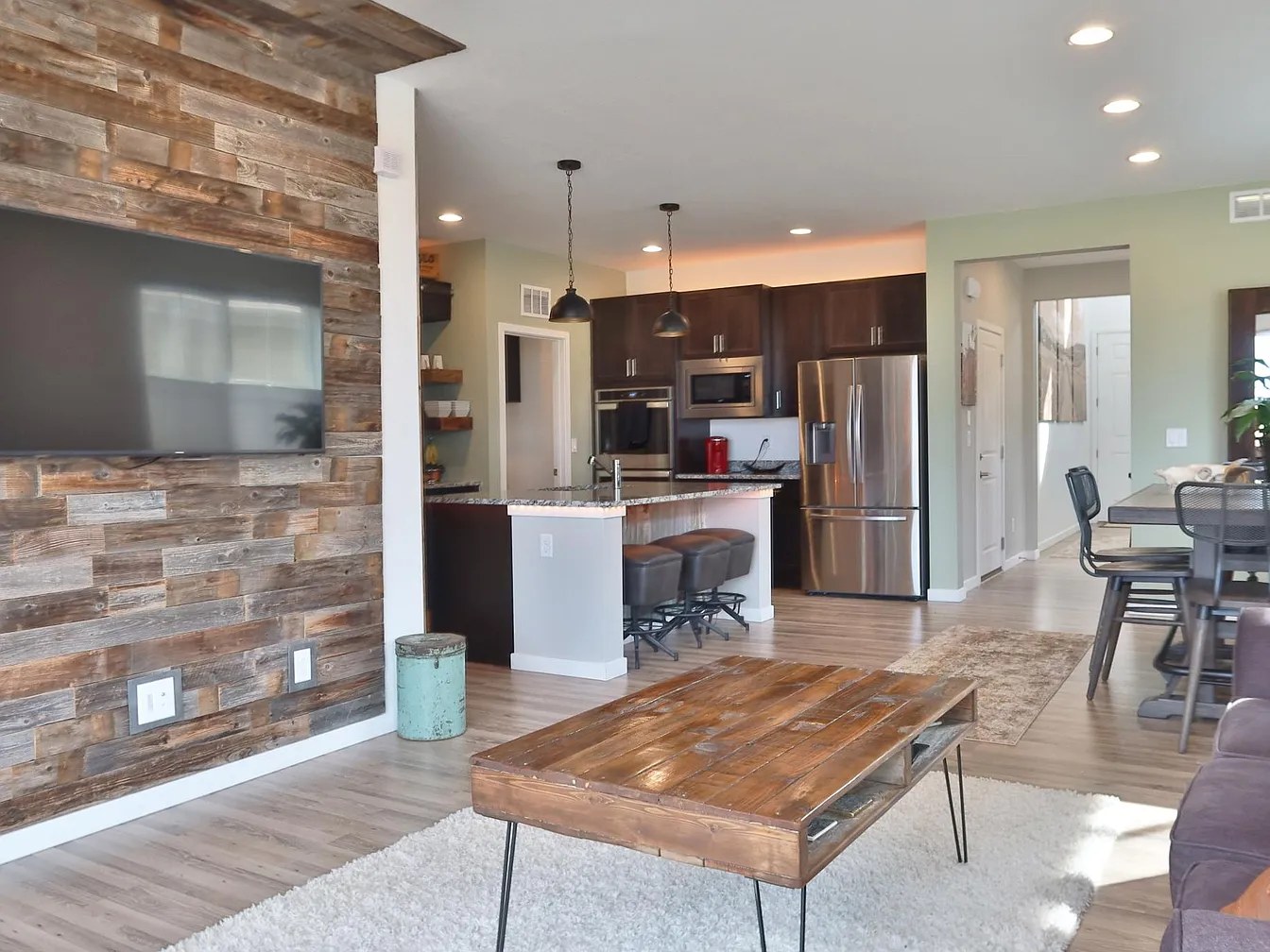 Open great room & kitchen with reclaimed barn-wood wall