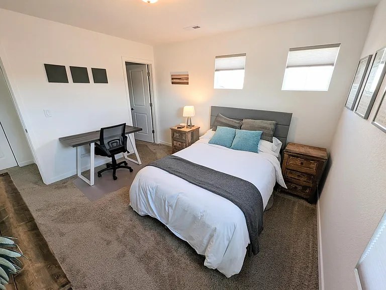 Guest bedroom workspace with desk and office chair