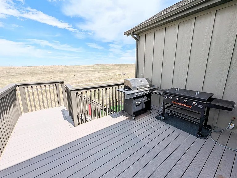 Back deck with gas grill & Blackstone griddle overlooking the prairie